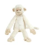 Ivory Monkey Plush Toy sitting on a soft blanket, showcasing its cuddly design.
