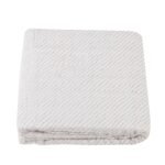 "Luxurious baby blanket made of soft spotted wave cotton muslin, providing cozy comfort for newborns. Perfect blend of style and snugness."