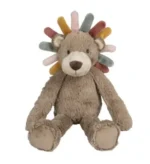 Cuddly Lion Cub Plush Toy sitting on a soft blanket, showcasing its adorable features.