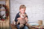 Child holding a large teddy bear.