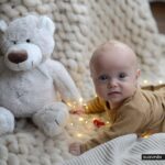Child playing with teddy bear.
