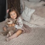 Child cuddling a stuffed animal