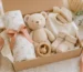 Newborn gift set with muslin swaddle, plush bear, bib, socks and wooden rattle